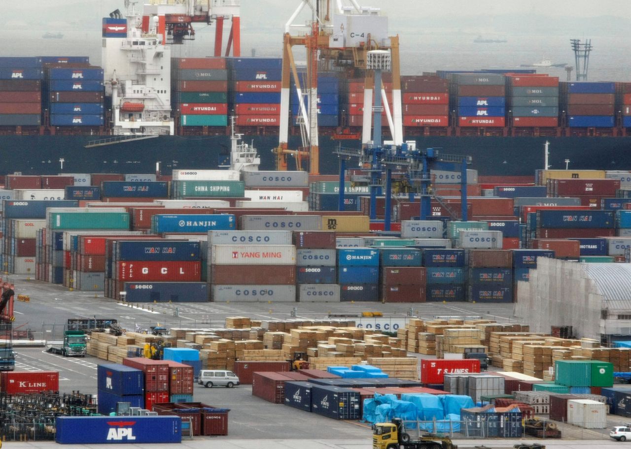 FILE PHOTO: Containers are seen at a pier of cargo area at a port in Yokohama, south of Tokyo December 22, 2008. REUTERS/Issei Kato/File Photo