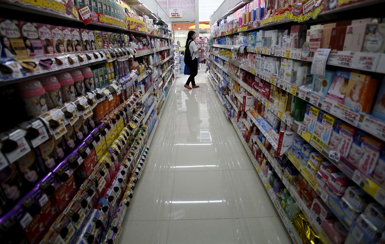 FILE PHOTO: A shopper looks at items at a drug store in Tokyo, Japan, May 28, 2015. Picture taken May 28, 2015. REUTERS/Yuya Shino