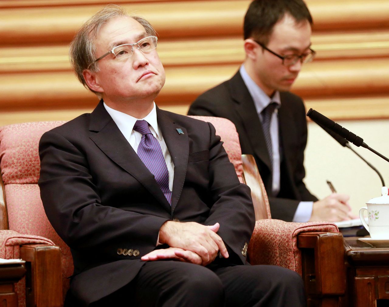 FILE PHOTO: Japanese Vice-Foreign Minister Takeo Akiba listens to Chinese Foreign Minister Wang Yi (not pictured) during their meeting at the Zhongnanhai Leadership Compound in Beijing, China August 29, 2018. How Hwee Young/Pool via REUTERS