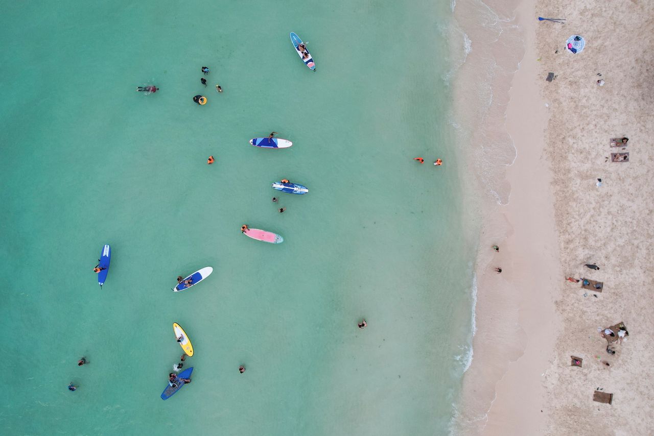 FILE PHOTO: People relax along White Beach amid the coranavirus disease (COVID-19) outbreak, in Boracay Island, Aklan province, Philippines, December 1, 2021. Picture taken December 1, 2021. Picture taken with drone. REUTERS/Eloisa Lopez/File Photo