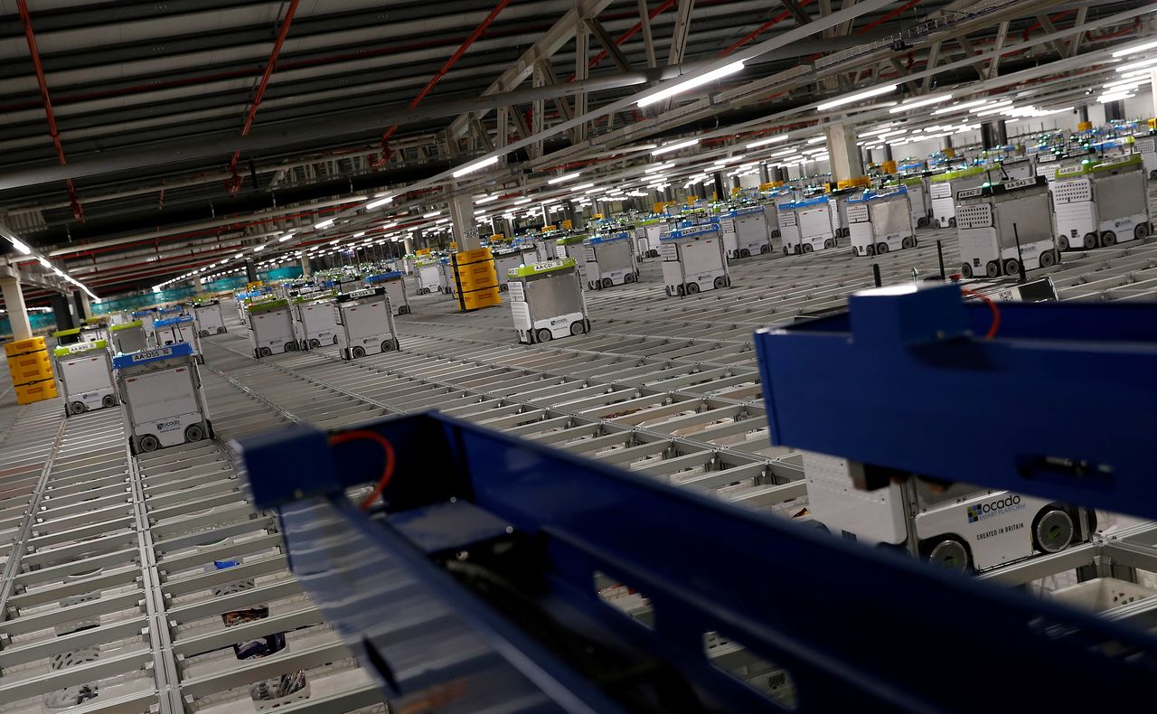 FILE PHOTO: "Bots" are seen on the grid of the "smart platform" at the Ocado CFC (Customer Fulfilment Centre) in Andover, Britain May 1, 2018.   REUTERS/Peter Nicholls/File Photo