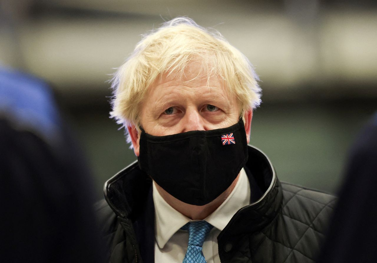 FILE PHOTO: British Prime Minister Boris Johnson wears a face mask as he visits RAF Valley in Anglesey, Britain January 27, 2022. REUTERS/Carl Recine