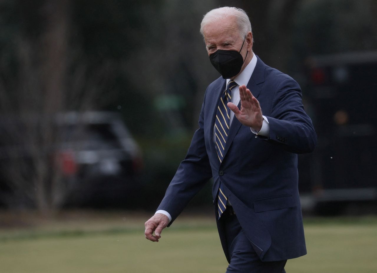 FILE PHOTO: U.S. President Joe Biden waves to members of the news media as he walks across the South Lawn to Marine One for travel to Pittsburgh from the White House in Washington, D.C., U.S., January 28, 2022. REUTERS/Leah Millis