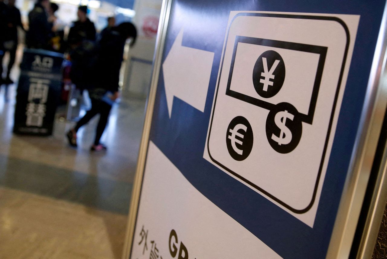 FILE PHOTO: Currency signs of the Japanese yen, euro and the U.S. dollar are seen on a board outside a currency exchange office at Narita International airport, near Tokyo, Japan, March 25, 2016.  REUTERS/Yuya Shino