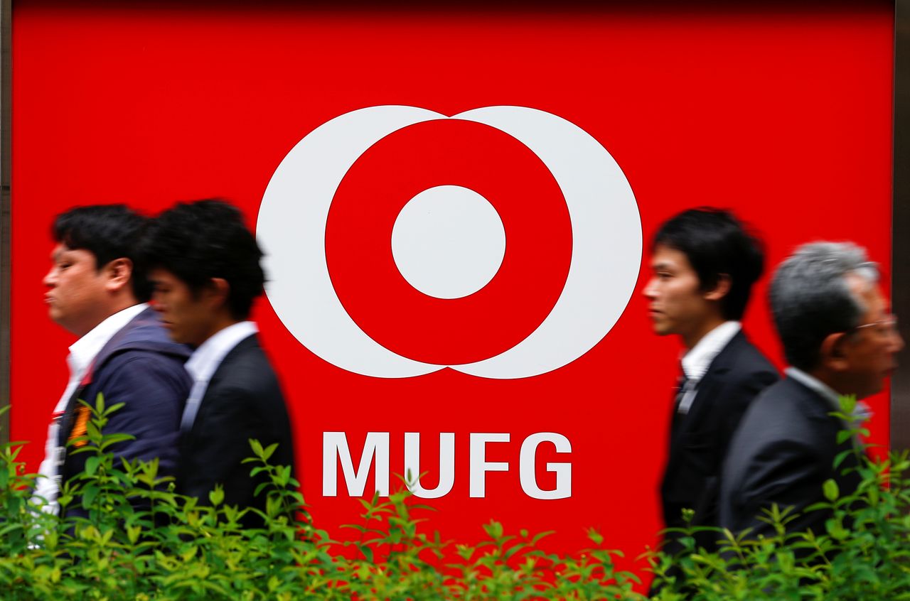 FILE PHOTO: People walk past a branch of Mitsubishi UFJ  Financial Group
