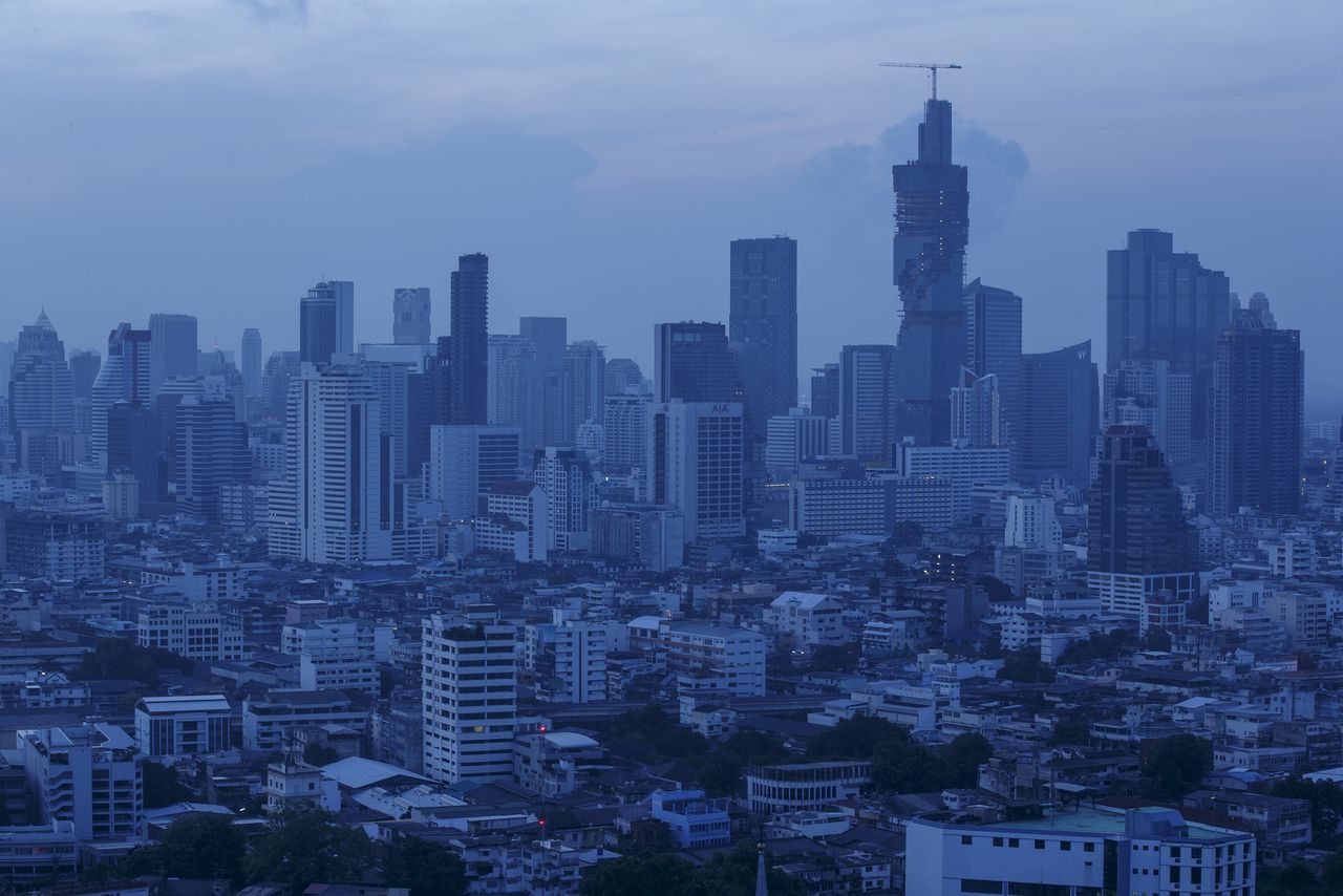 FILE PHOTO: The skyline of central Bangkok is seen before sunrise in Bangkok April 22, 2015. REUTERS/Athit Perawongmetha