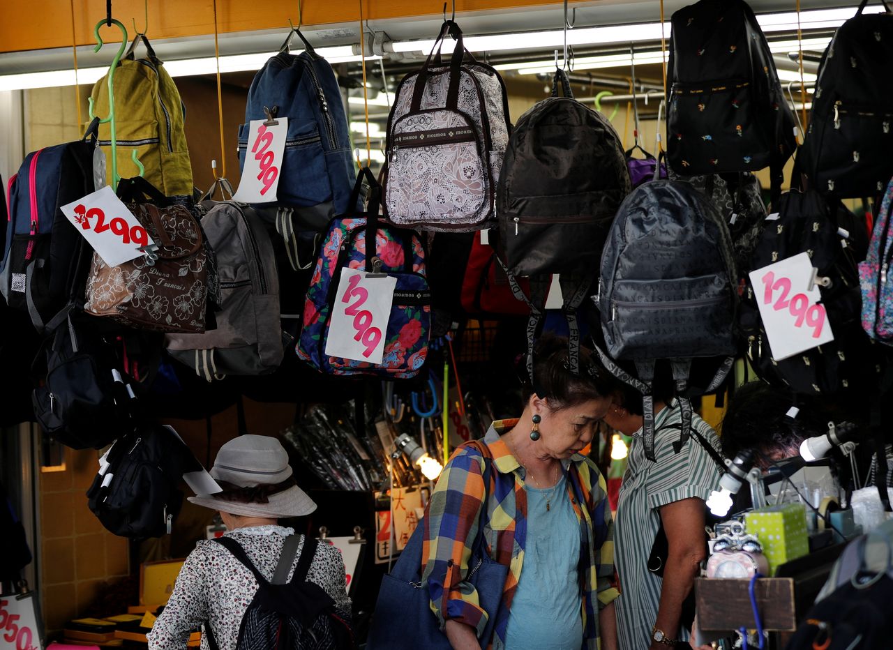FILE PHOTO: Shoppers look around goods at a shop in Tokyo, Japan October 1, 2019. REUTERS/Kim Kyung-Hoon