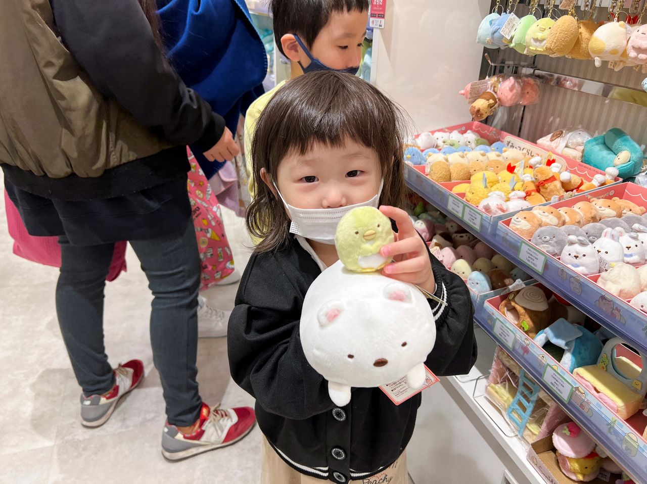 Children of Keiki Nambu and his wife Takako enjoy shopping, amid the coronavirus disease (COVID-19) pandemic, in Tokyo, Japan January 7, 2022. Picture taken January 7, 2022.  REUTERS/Akiko Okamoto
