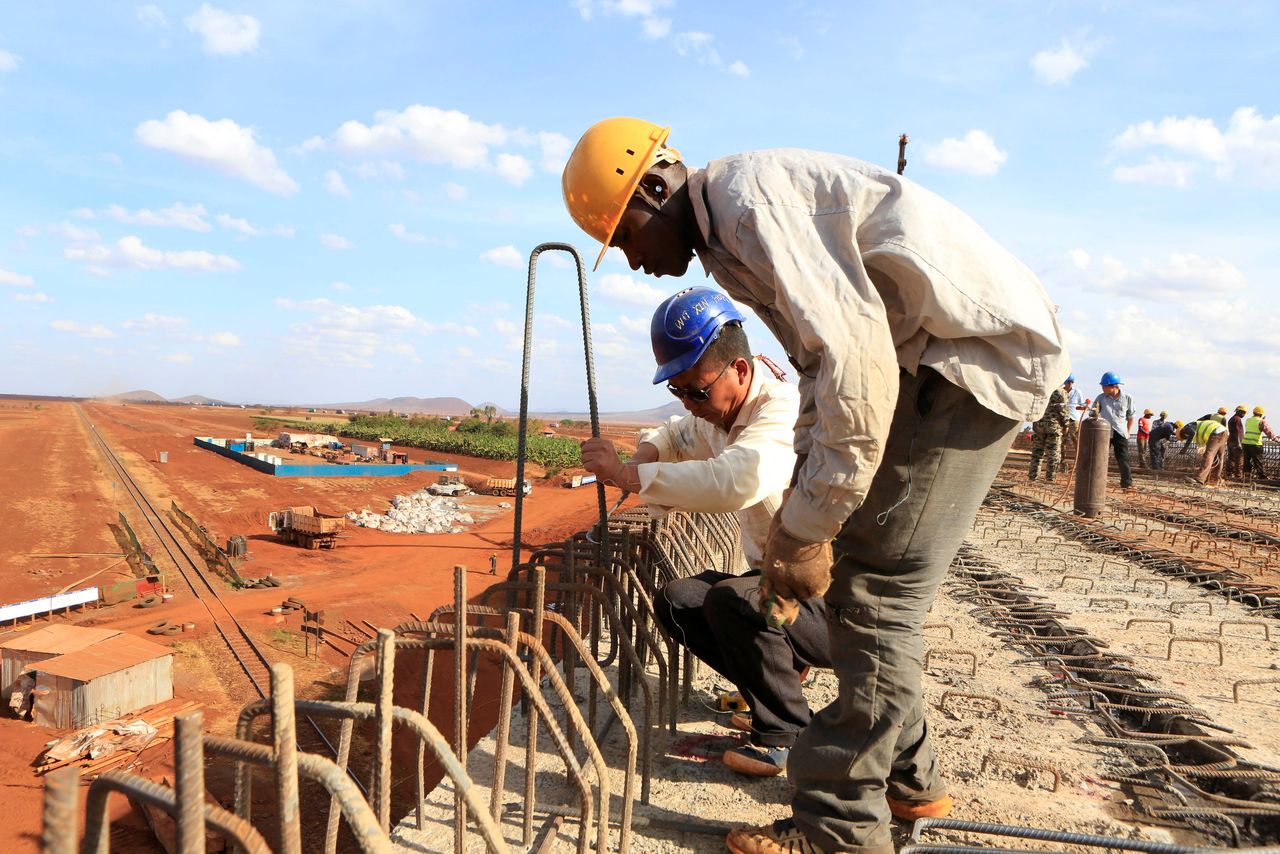 FILE PHOTO: A Chinese engineer and a local construction worker work on a section of the Mombasa-Nairobi standard gauge railway (SGR) in Emali, Kenya October 10, 2015. REUTERS/Noor Khamis