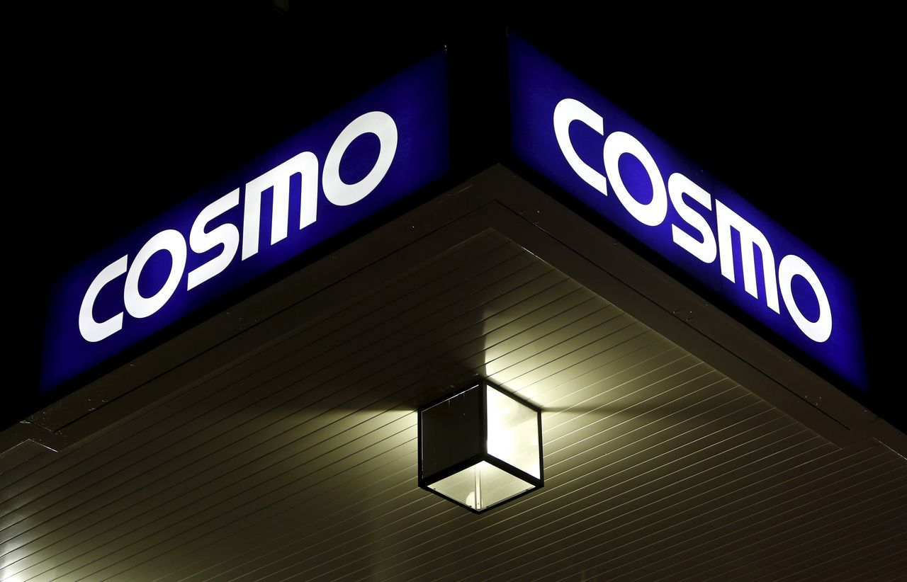 FILE PHOTO: A light is seen under a signboard of Cosmo Energy Holdings