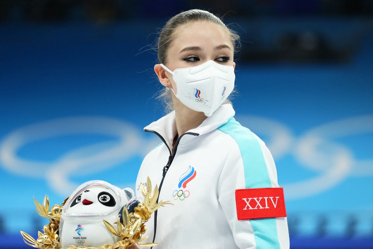 2022 Beijing Olympics - Figure Skating - Team Event - Women Single Skating - Free Skating - Capital Indoor Stadium, Beijing, China - February 7, 2022. Kamila Valieva of the Russian Olympic Committee after winning gold during the flower ceremony. REUTERS/Aleksandra Szmigiel