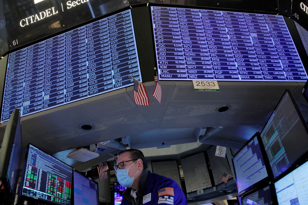 FILE PHOTO: A Specialist Trader works inside a booth on the floor of the New York Stock Exchange (NYSE) in New York City, U.S., January 25, 2022.  REUTERS/Brendan McDermid/File Photo