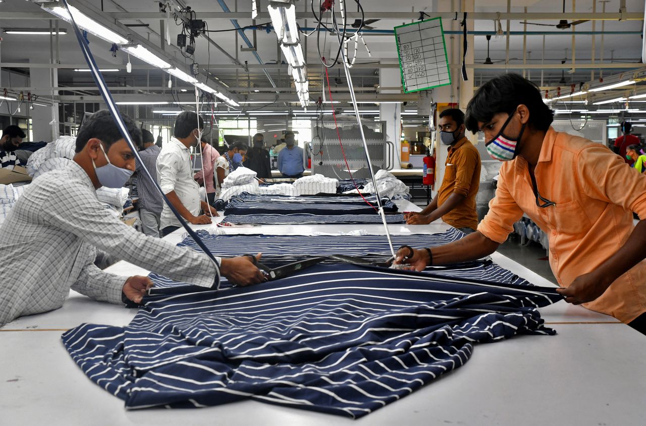 Garment workers cut fabric to make shirts at a textile factory of Texport Industries in Hindupur town in the southern state of Andhra Pradesh, India, February 9, 2022.  REUTERS/Samuel Rajkumar