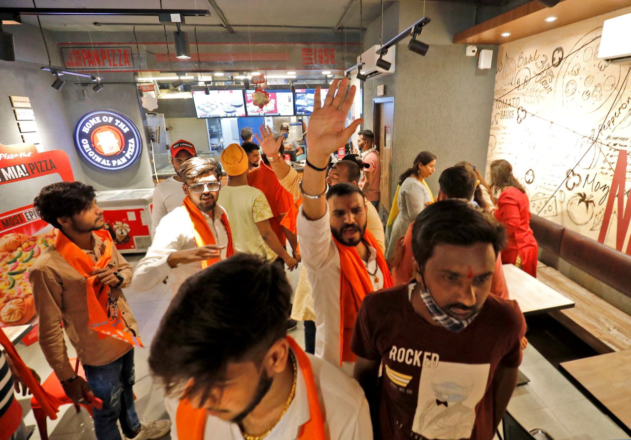 Activists of Bajrang Dal, a Hindu hardline group, shout slogans inside a Pizza Hut food outlet during a protest over their Pakistani partners