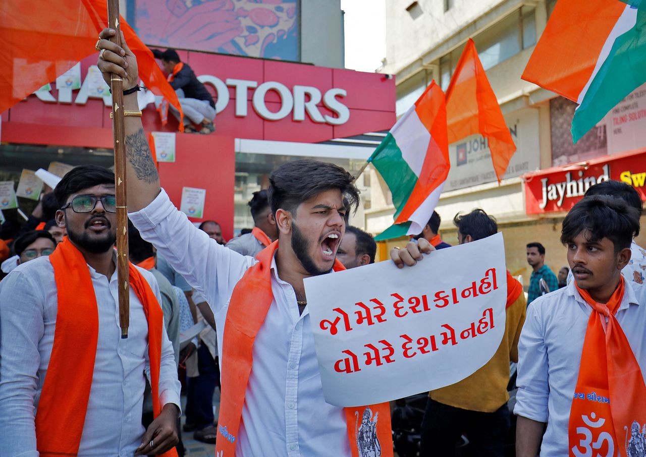 An activist of Bajrang Dal, a Hindu hardline group, shouts slogans in front of a KIA Motors showroom during a protest over their Pakistani partners