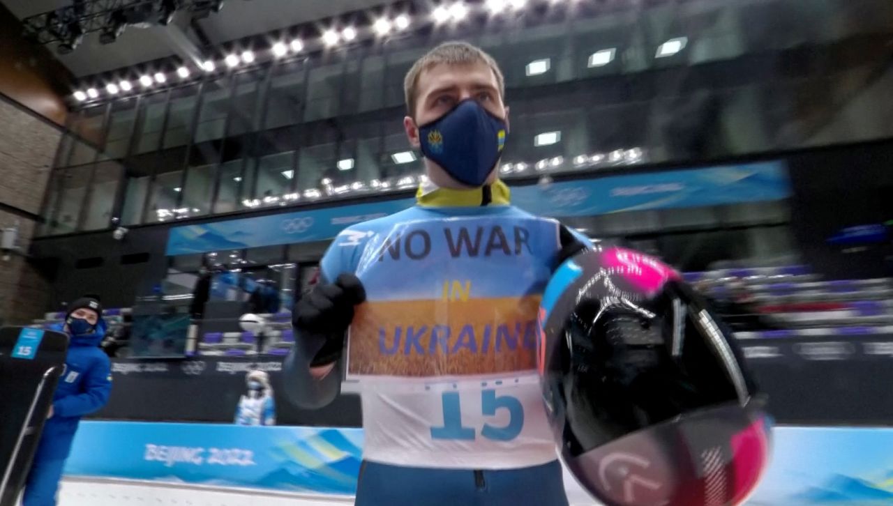 2022 Beijing Olympics - Skeleton - National Sliding Centre, Yanqing District, Beijing, China - February 11, 2022. Vladyslav Heraskevych of Ukraine holds a sign with a message reading 