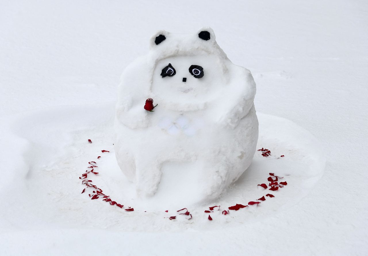 A snowman depicting the Beijing Winter Olympics mascot Bing Dwen Dwen is pictured outside a media hotel in Zhangjiakou, China. February 13, 2022 REUTERS/Hannah McKay