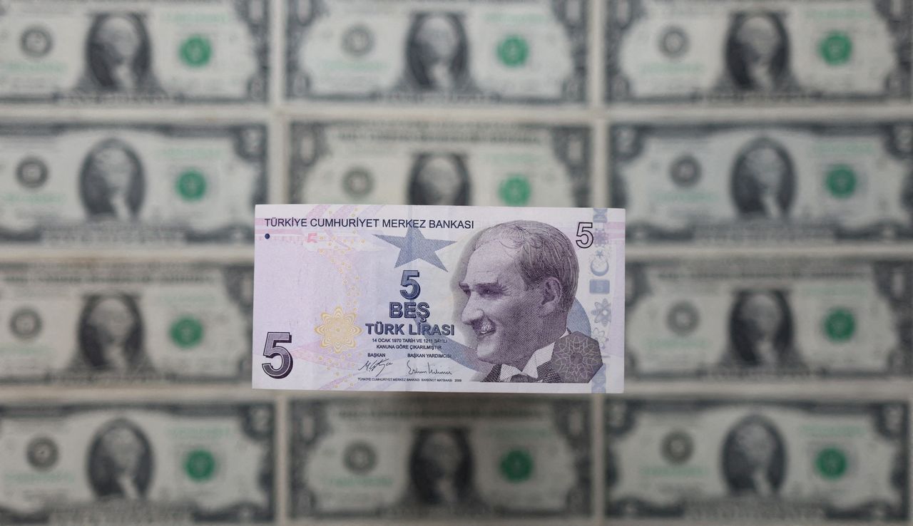FILE PHOTO: Turkish lira banknote is displayed on U.S. Dollar banknotes in this illustration taken, February 14, 2022. REUTERS/Dado Ruvic/Illustration