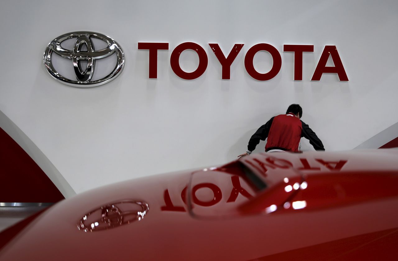 FILE PHOTO: An employee works under a Toyota Motor Corp logo at the company