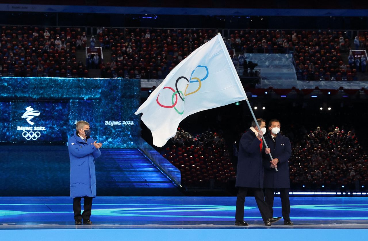 2022 Beijing Olympics - Closing Ceremony - National Stadium, Beijing, China - February 20, 2022. International Olympic Committee (IOC) President Thomas Bach hands the Olympic flag to Guiseppe Sala, Mayor of Milano City and Gianpetro Ghedina, Mayor of Cortina d