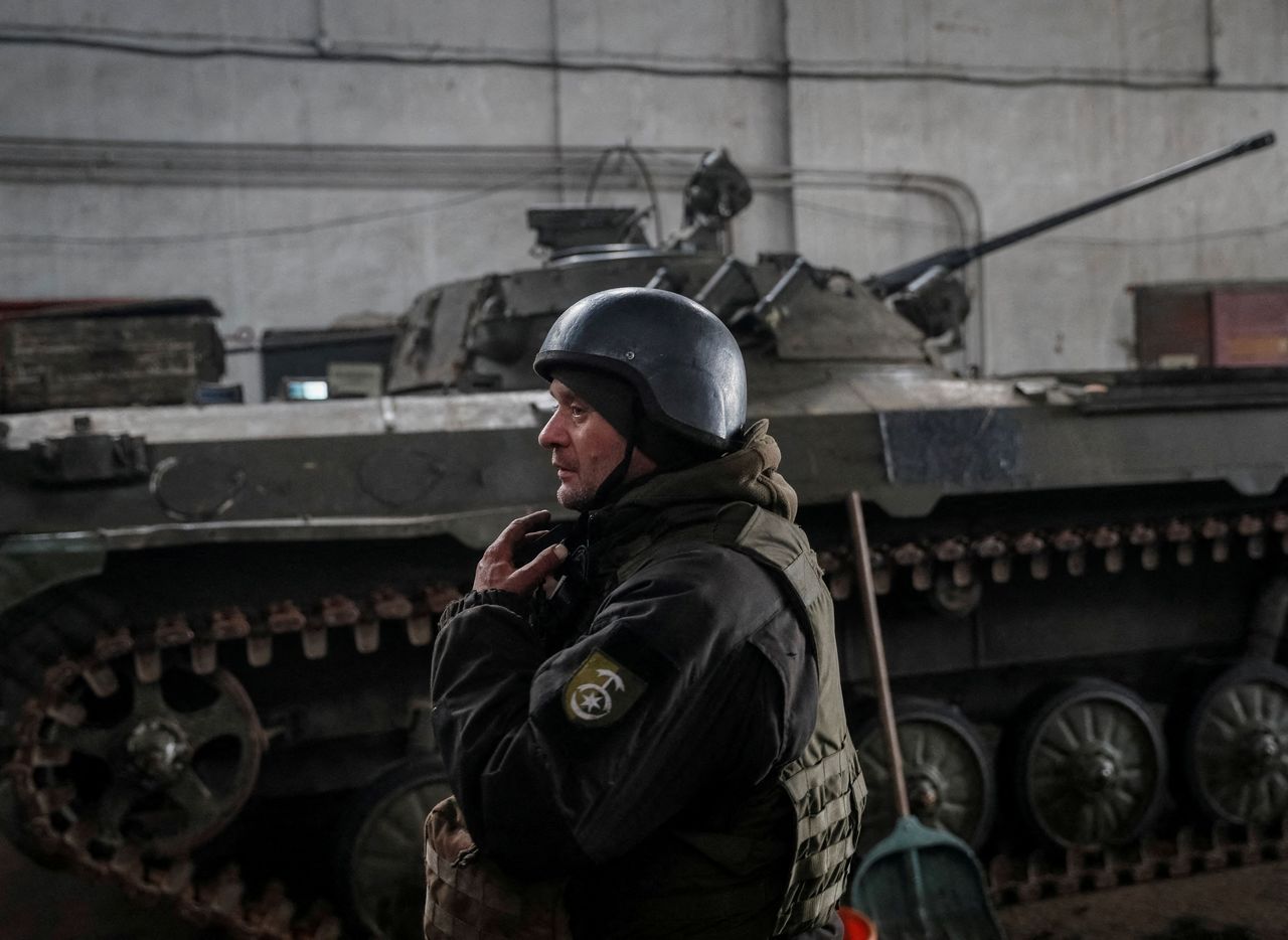 FILE PHOTO: A Ukrainian service member stands near an infantry fighting vehicle on the front line near the city of Novoluhanske in the Donetsk region, Ukraine February 22, 2022. REUTERS/Gleb Garanich/File Photo