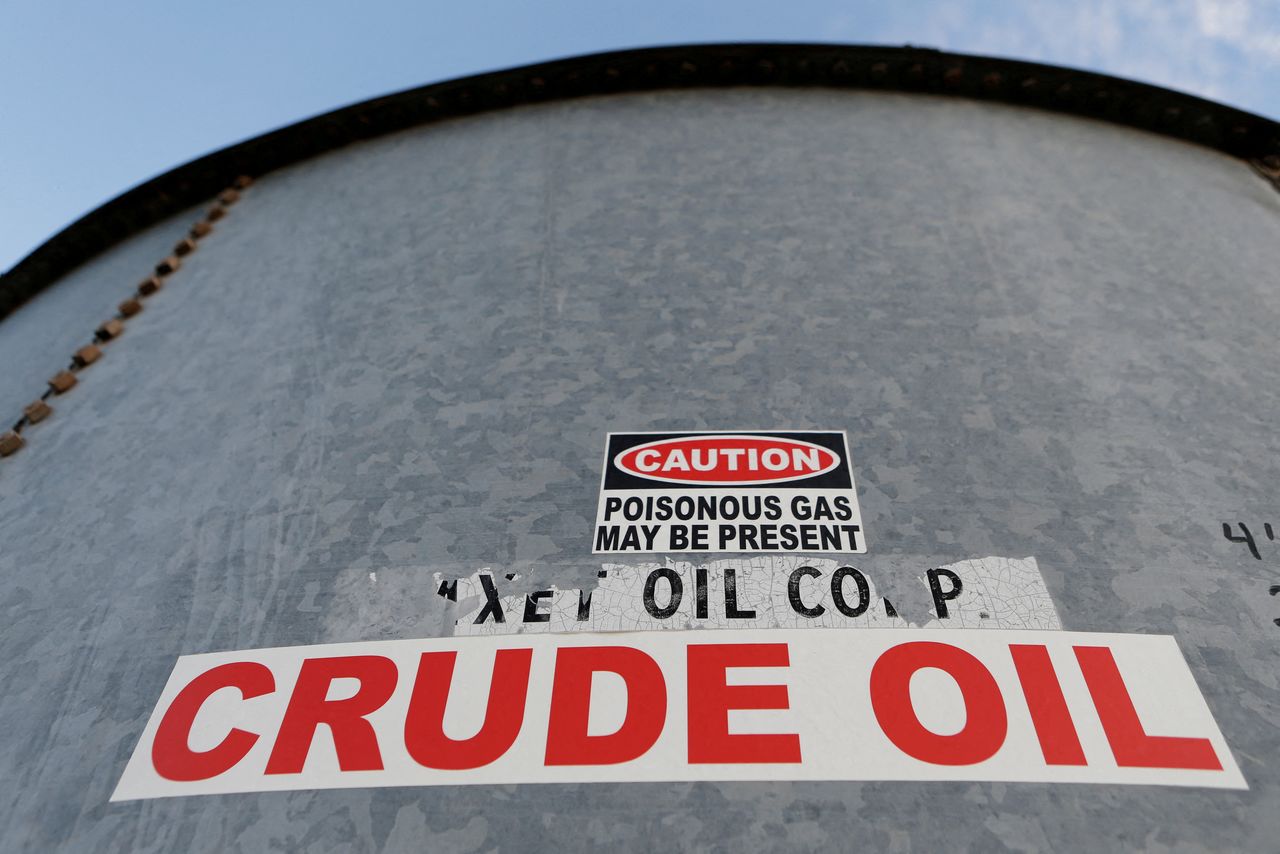 FILE PHOTO: A sticker reads crude oil on the side of a storage tank in the Permian Basin in Mentone, Loving County, Texas, U.S. November 22, 2019. Picture taken November 22, 2019. REUTERS/Angus Mordant