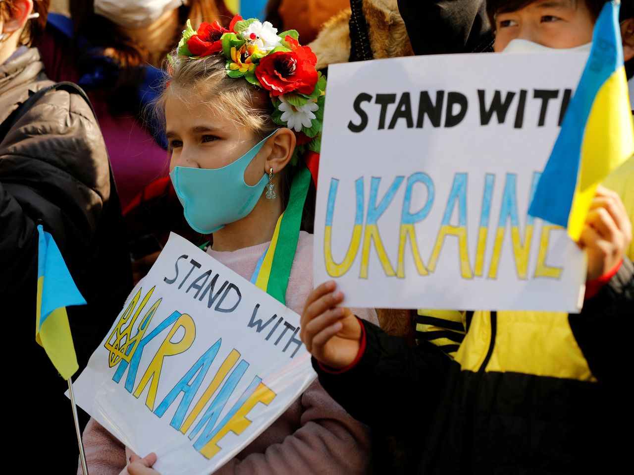 Ukrainian children hold banners during a rally against Russia