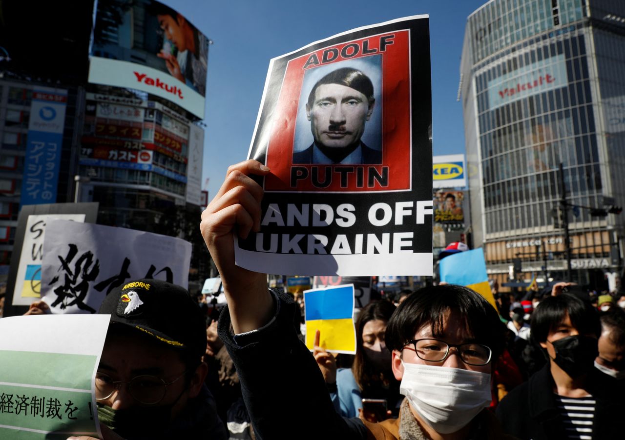 Protesters hold banners during a rally against Russia