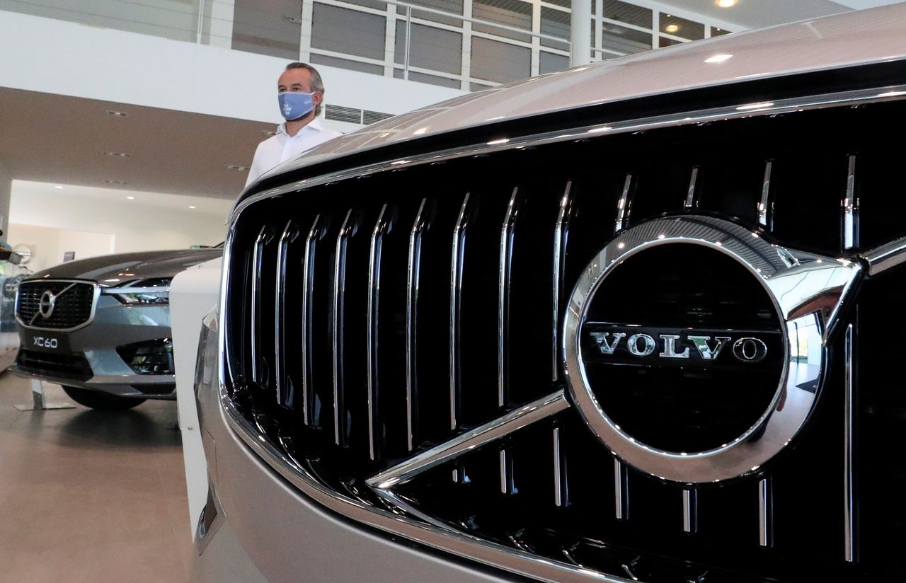 FILE PHOTO: An employee at a Volvo car dealer, wearing a protective mask is seen in a showroom, in Brussels, Belgium, May 28, 2020. REUTERS/Yves Herman