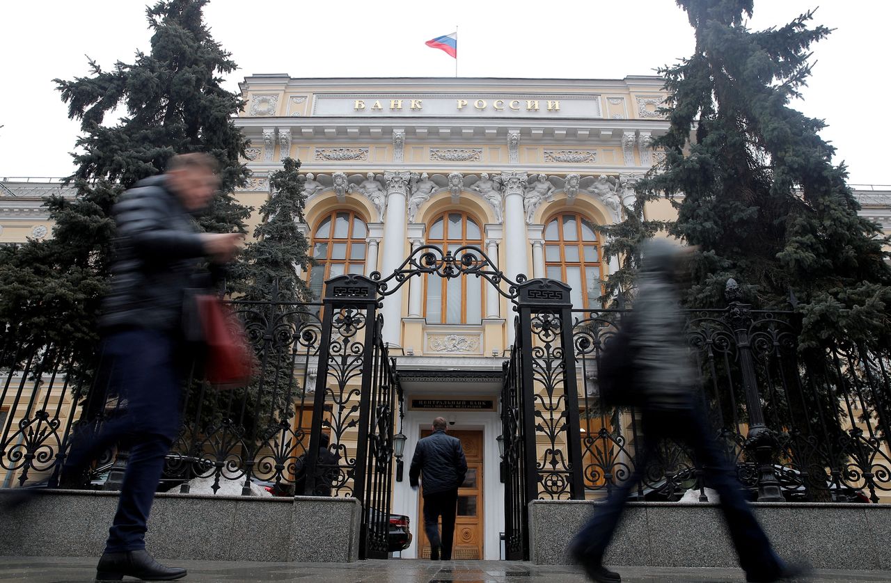 FILE PHOTO: People walk past the Central Bank headquarters in Moscow, Russia February 11, 2019. REUTERS/Maxim Shemetov/File Photo