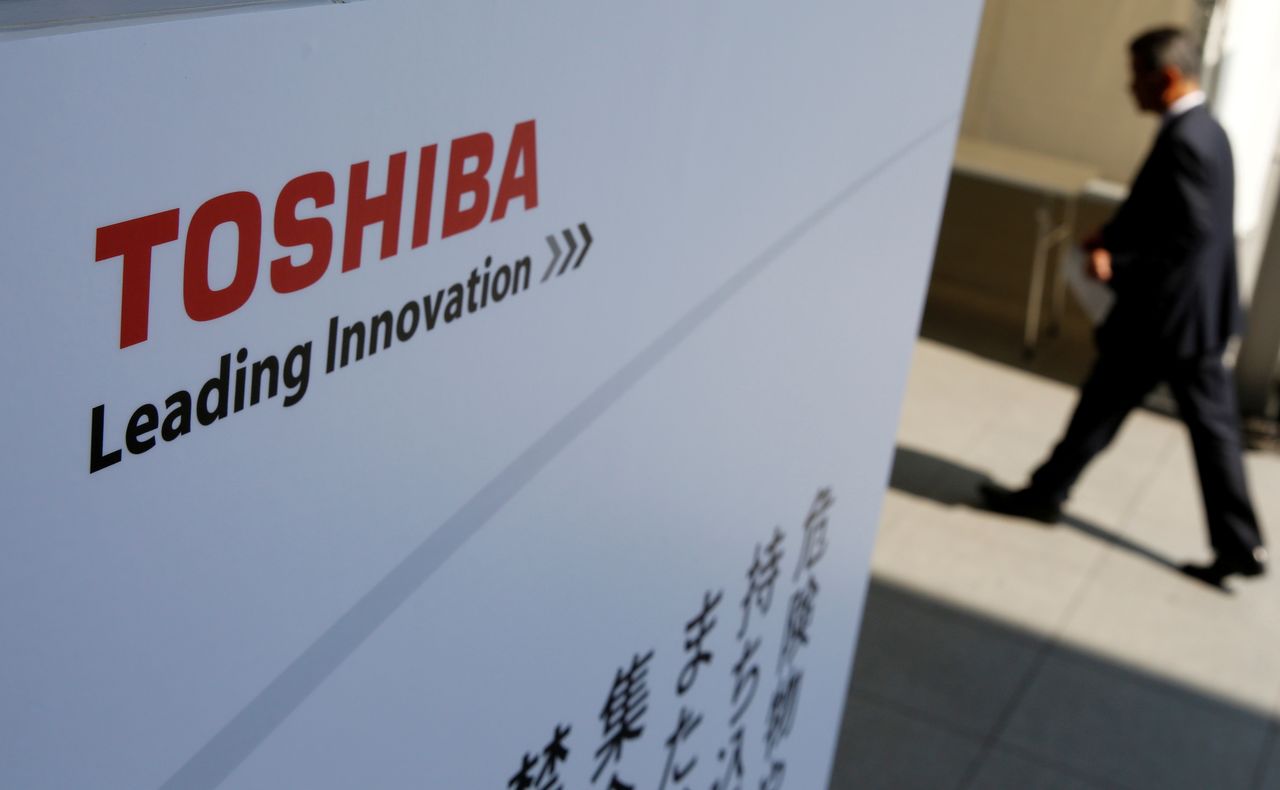 FILE PHOTO: The logo of Toshiba is seen as a shareholder arrives at an extraordinary shareholders meeting in Chiba, Japan, March 30, 2017. REUTERS/Toru Hanai