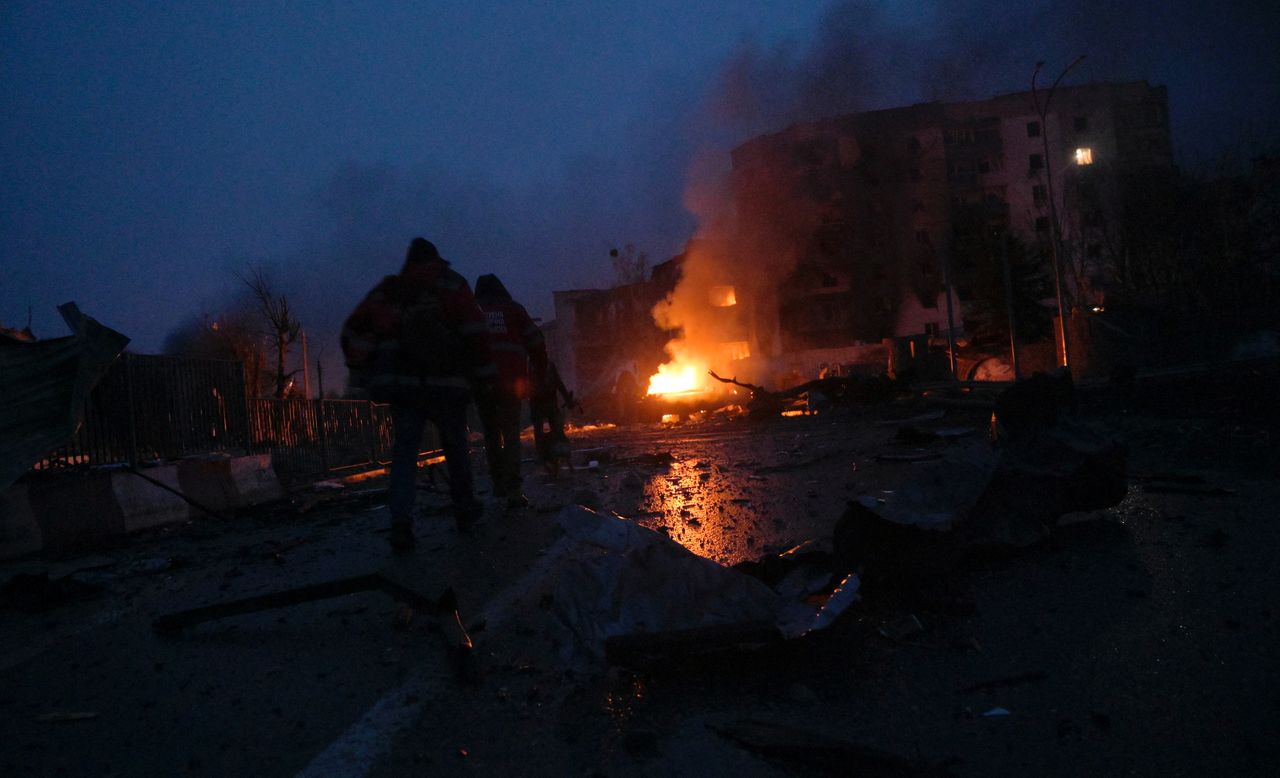 Paramedics walk at the residential area following recent shelling, as Russia