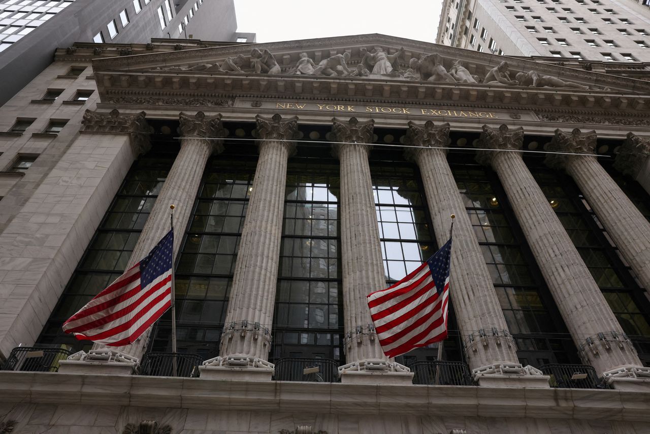 FILE PHOTO: Flags are seen outside the New York Stock Exchange (NYSE) in New York City, where markets roiled after Russia continues to attack Ukraine, in New York, U.S., February 24, 2022.   REUTERS/Caitlin Ochs