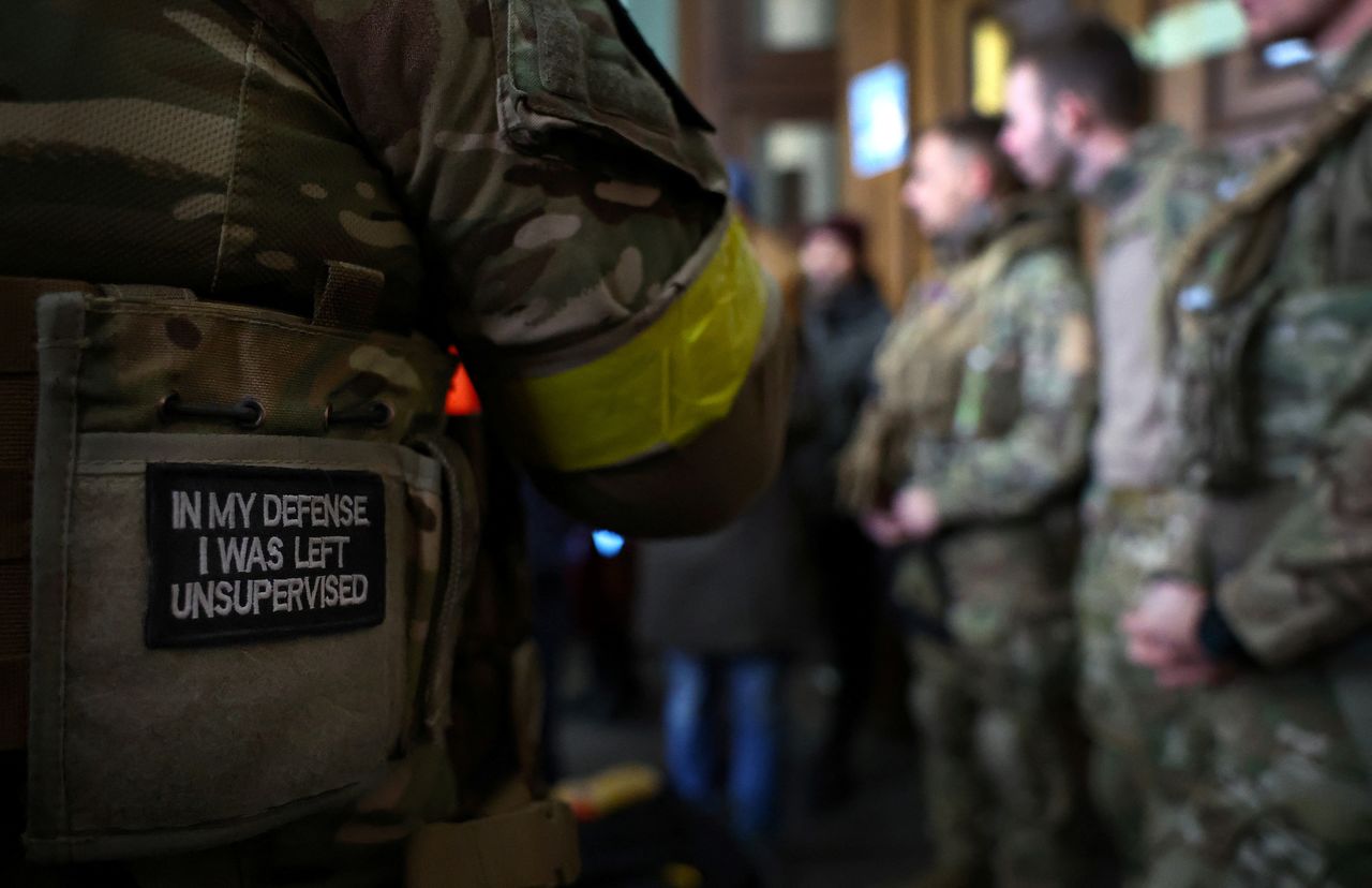 A badge is pictured on a uniform of a foreign fighter from the UK as he and other volunteers are ready to depart towards the front line in the east of Ukraine following the Russian invasion, at the main train station in Lviv, Ukraine, March 5, 2022. Picture taken March 5, 2022.   REUTERS/Kai Pfaffenbach