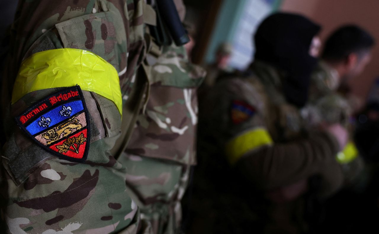 A badge is pictured on a uniform of a foreign fighter from the UK as they are ready to depart towards the front line in the east of Ukraine following the Russian invasion, at the main train station in Lviv, Ukraine, March 5, 2022. REUTERS/Kai Pfaffenbach