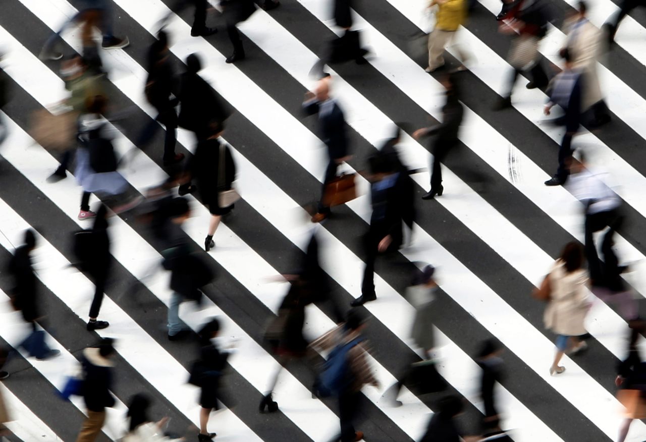 FILE PHOTO: People cross a street in Tokyo March 18, 2015. . REUTERS/Yuya Shino