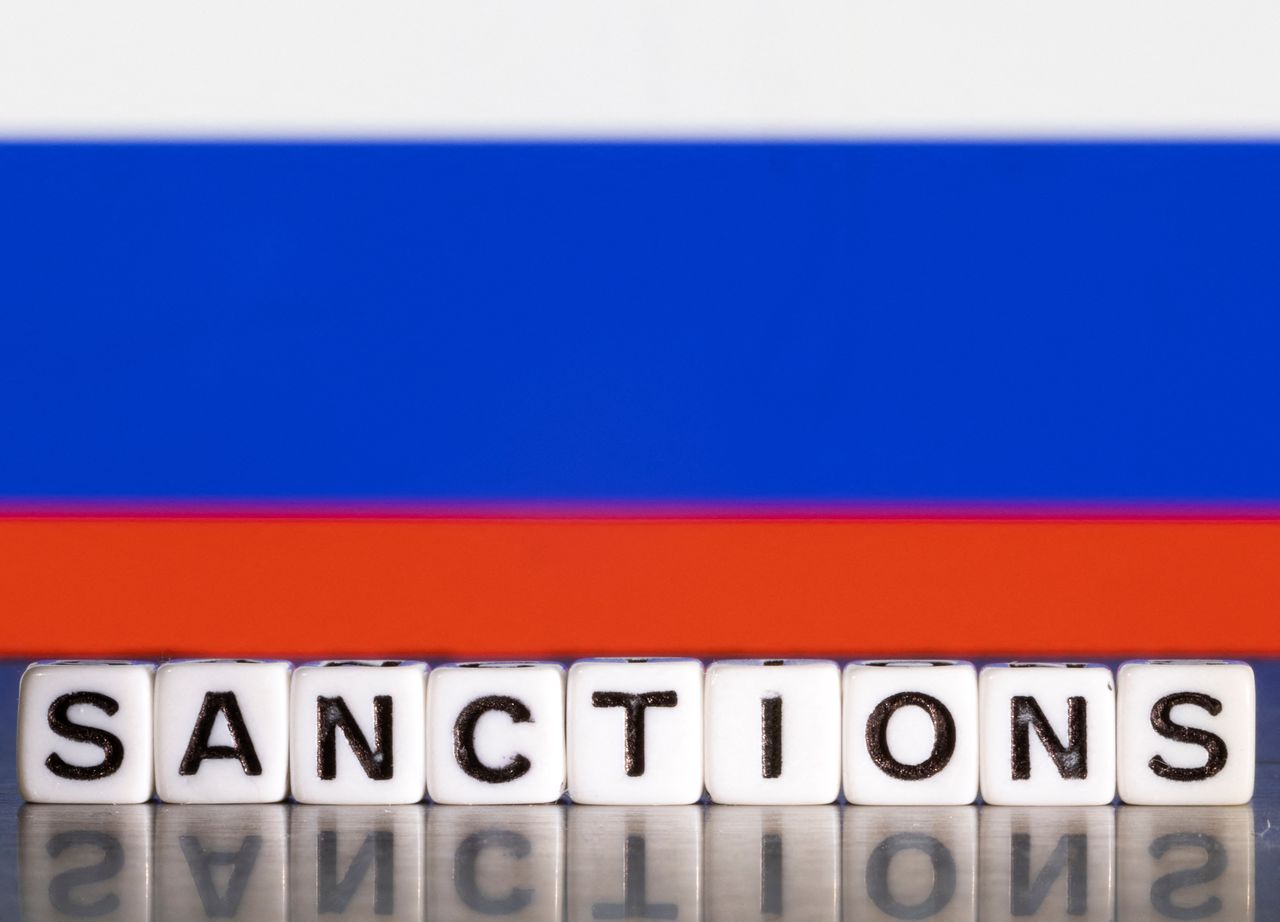 FILE PHOTO: Plastic letters arranged to read "Sanctions" are placed in front Russian flag colors in this illustration taken February 28, 2022. REUTERS/Dado Ruvic/Illustration