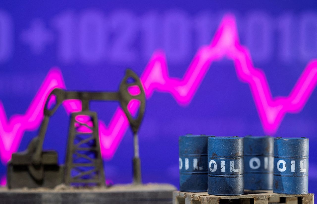 FILE PHOTO: Models of oil barrels and a pump jack are displayed in front of a rising stock graph and "$100" in this illustration taken February 24, 2022. REUTERS/Dado Ruvic/Illustration