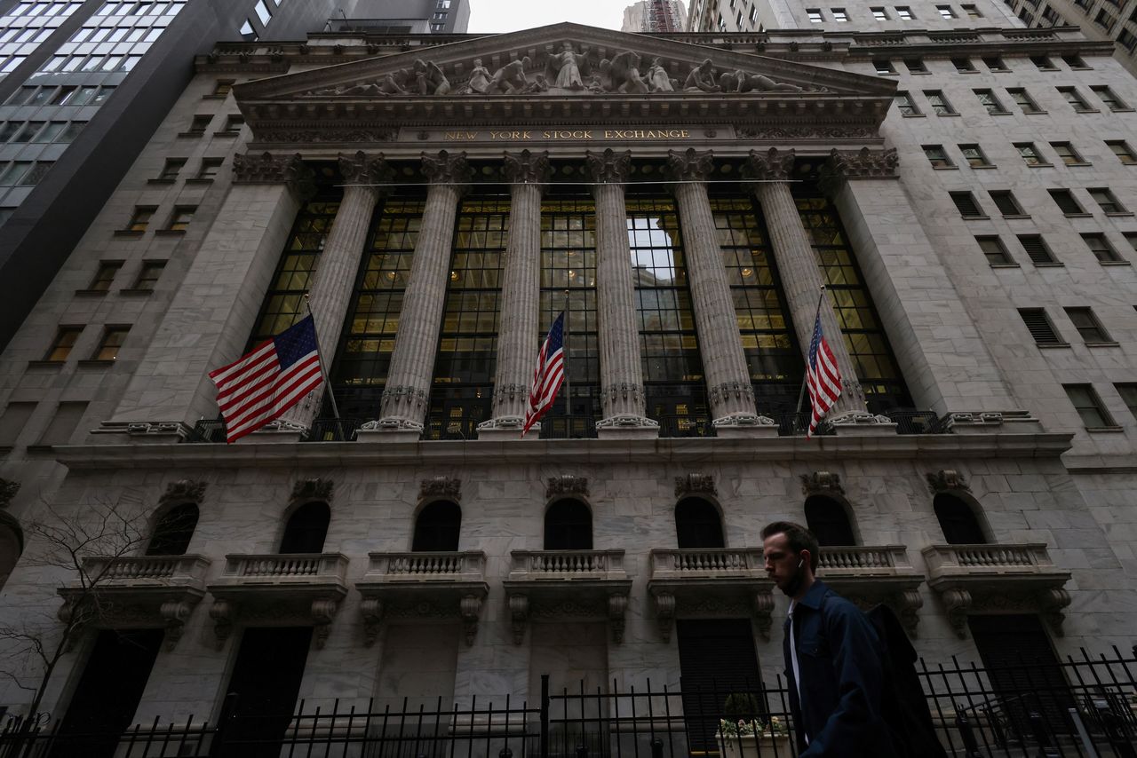 A person walks past the New York Stock Exchange (NYSE) in Manhattan, New York City, U.S., March 7, 2022. REUTERS/Andrew Kelly