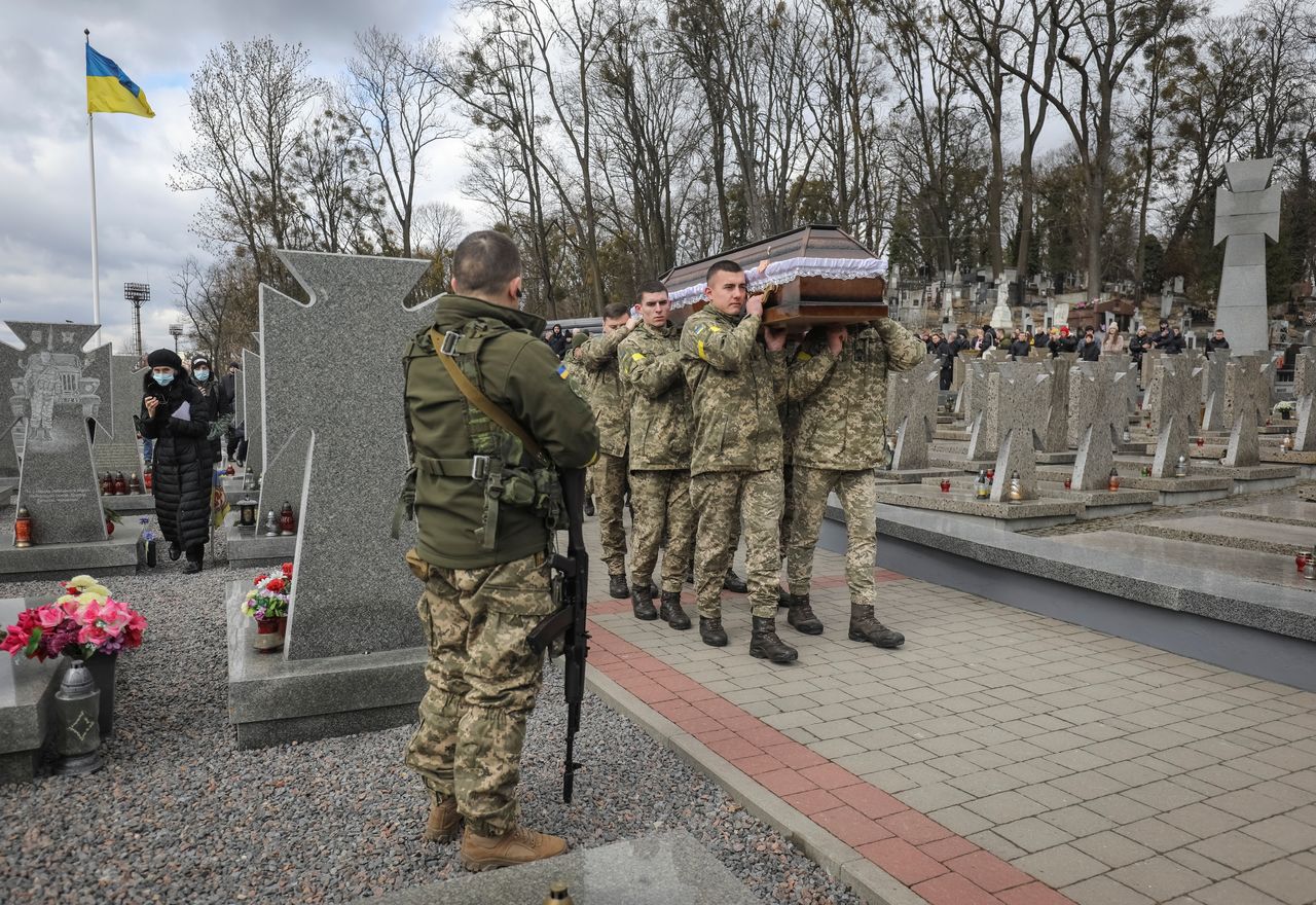 Service members carry coffins of  Viktor Dudar and  Ivan Koverznev, Ukrainian servicemen killed on March 2 during Russia