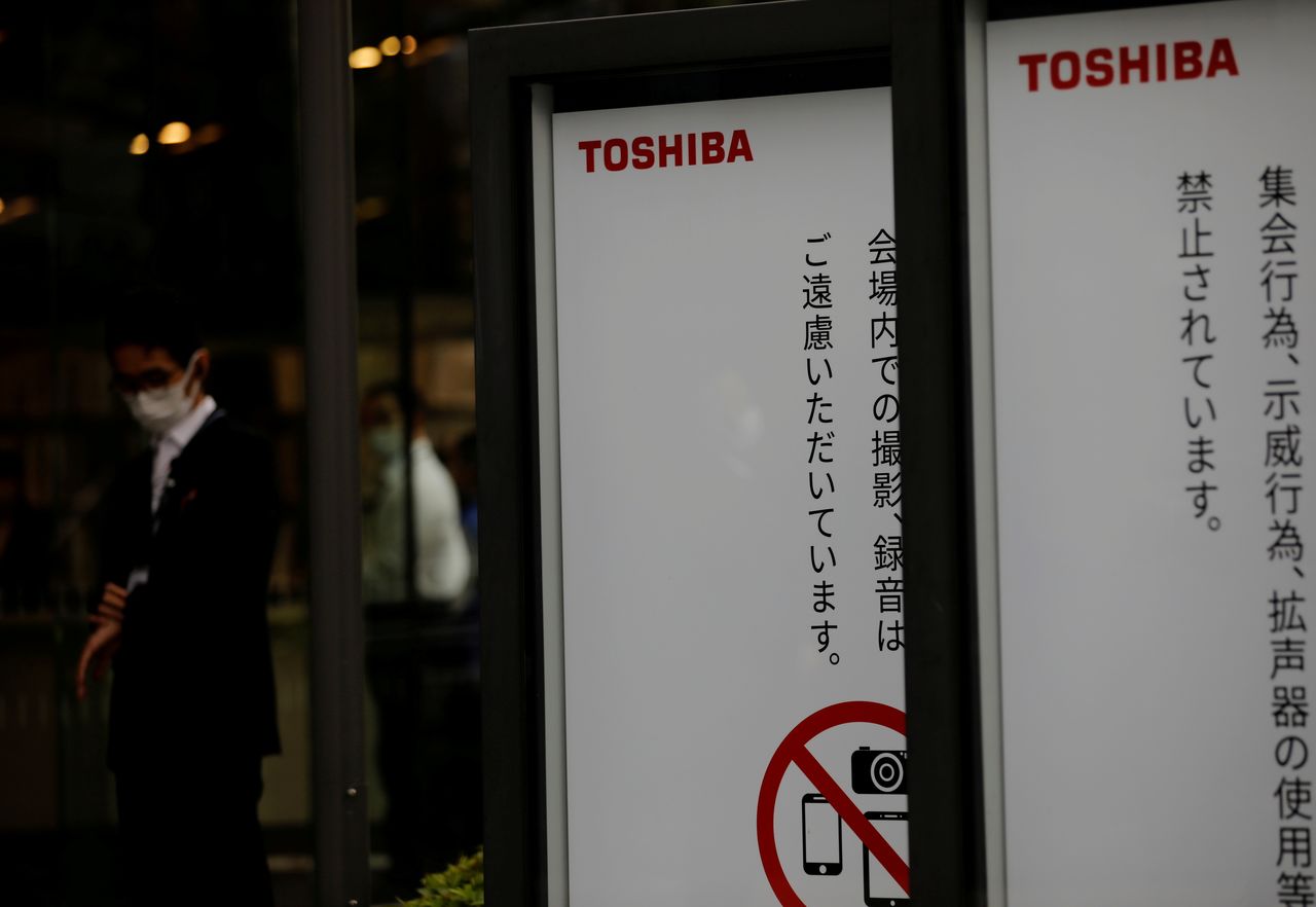 A staff stands in front of a venue of Toshiba Corp