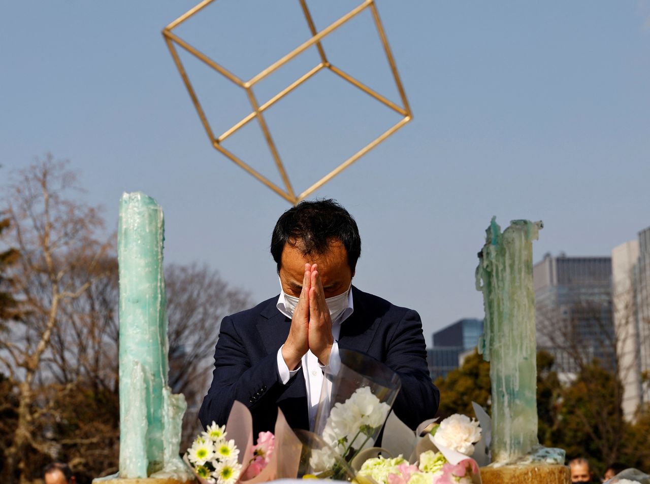 A man wearing a protective mask, amid the coronavirus disease (COVID-19) outbreak, prays to mourn the victims of the March 11, 2011 earthquake and tsunami, on the 11th anniversary of the events that killed thousands and set off a nuclear crisis, in Tokyo, Japan March 11, 2022. REUTERS/Kim Kyung-Hoon