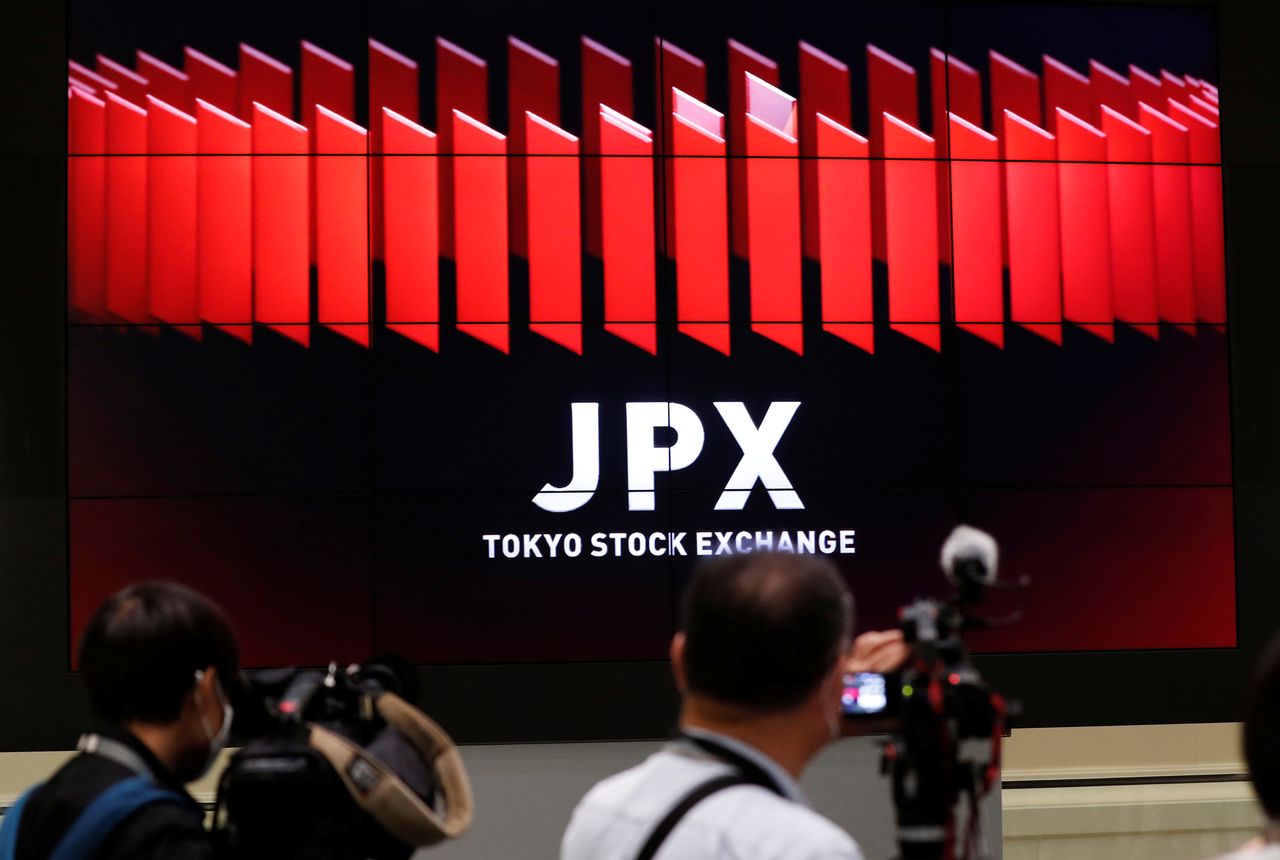 FILE PHOTO: TV camera men wait for the opening of market in front of a large screen showing stock prices at the Tokyo Stock Exchange in Tokyo, Japan October 2, 2020. REUTERS/Kim Kyung-Hoon