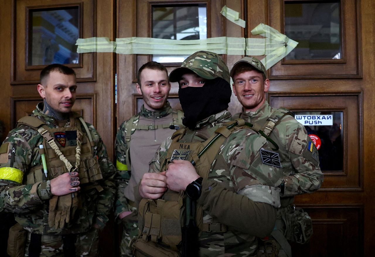 FILE PHOTO: Four foreign fighters from the UK pose for a picture prior to their departure towards the front line in the east of Ukraine following the Russian invasion, at the main train station in Lviv, Ukraine, March 5, 2022. Picture taken March 5, 2022. REUTERS/Kai Pfaffenbach/File Photo