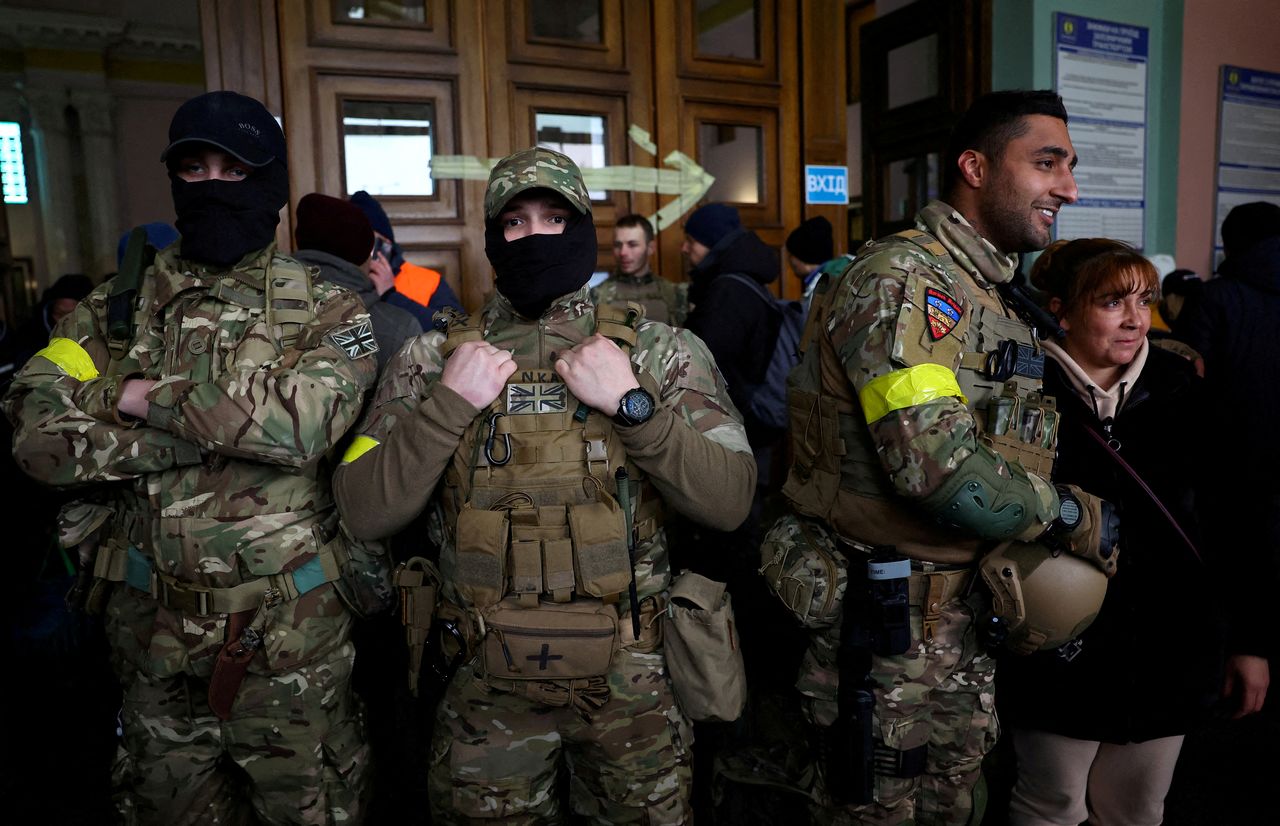 FILE PHOTO: Ben Grant and other foreign fighters from the UK pose for a picture as they are ready to depart towards the front line in the east of Ukraine following the Russian invasion, at the main train station in Lviv, Ukraine, March 5, 2022. REUTERS/Kai Pfaffenbach/File Photo