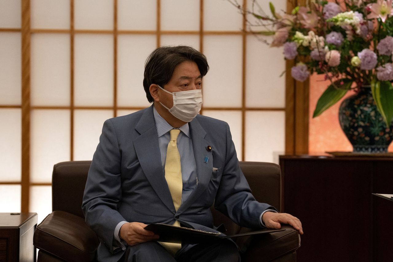 FILE PHOTO: Japan’s Foreign Minister, Yoshimasa Hayashi, talks with the Ukrainian ambassador to Japan, Sergiy Korsunsky, following the Russian invasion of Ukraine, in Tokyo, Japan, March 2, 2022. Carl Court/Pool via REUTERS