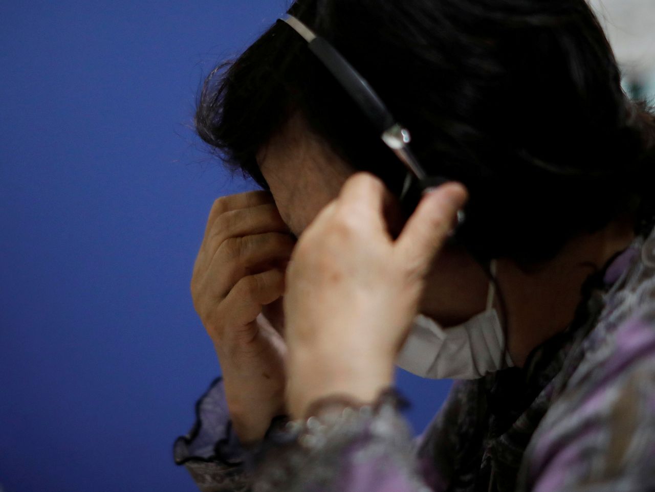 FILE PHOTO: A volunteer responds an incoming call at the Tokyo Befrienders call center, a Tokyo