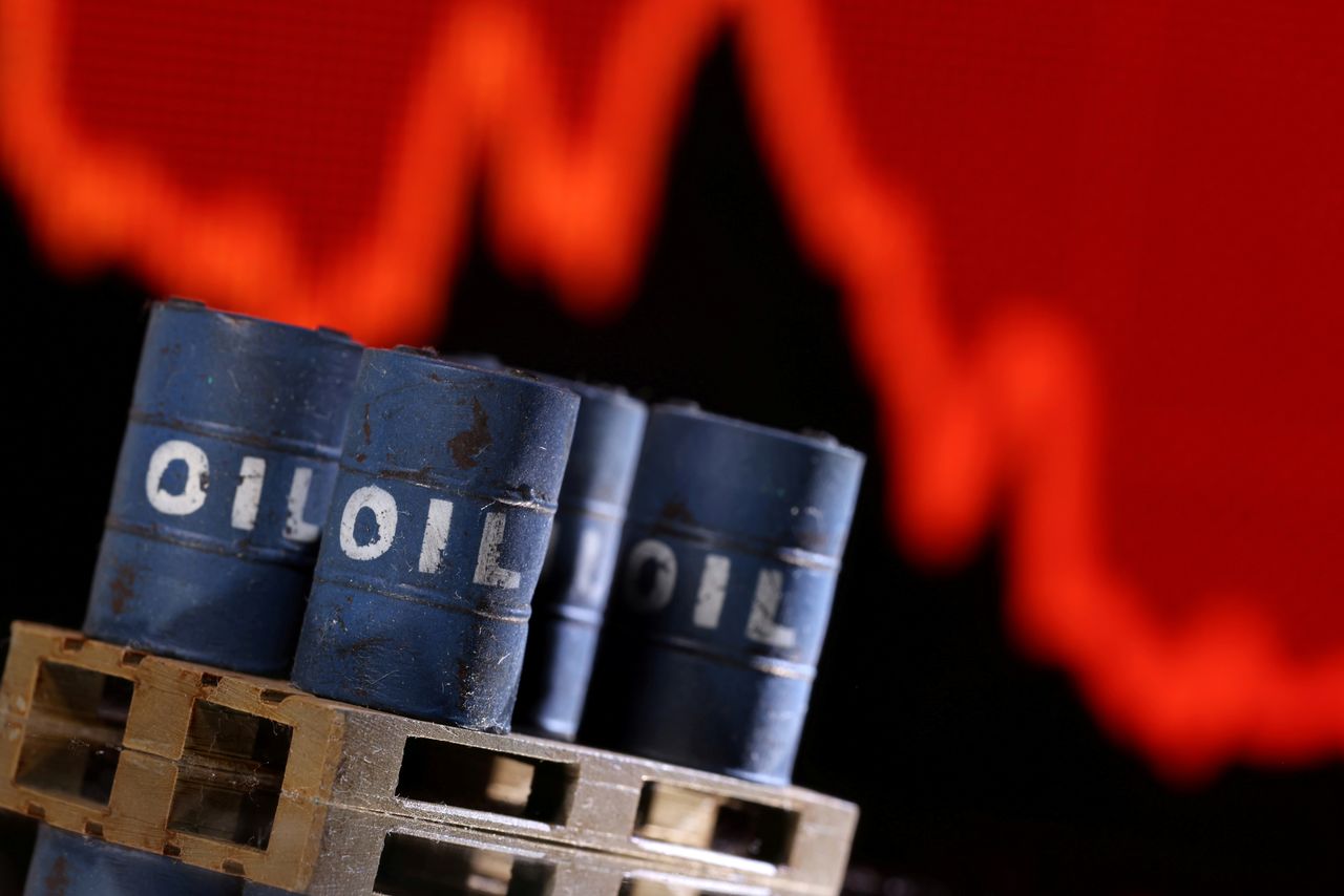 A model of 3D printed oil barrels is seen in front of displayed stock graph going down in this illustration taken, December 1, 2021. REUTERS/Dado Ruvic/Illustration