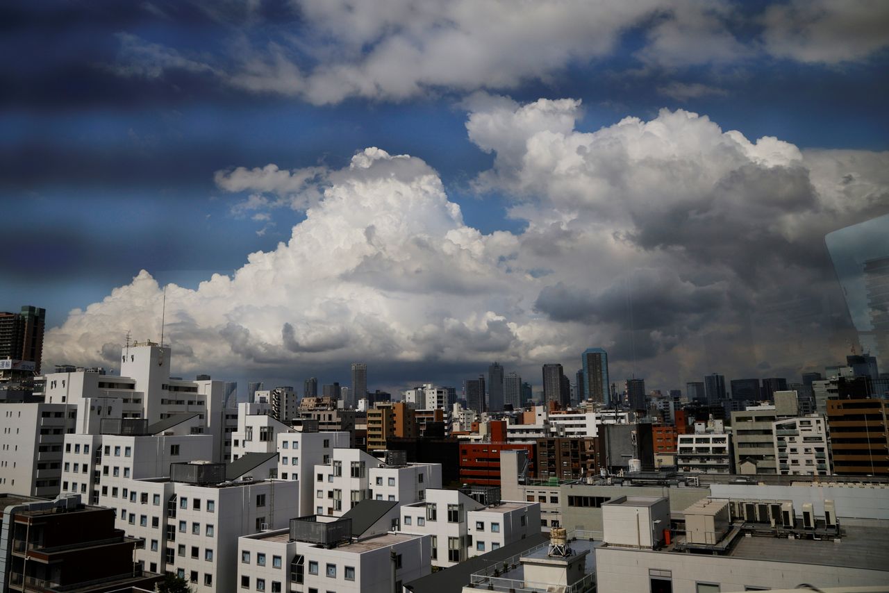 FILE PHOTO: Clouds hang over the skyline as seen from a media bus during the Tokyo 2020 Olympic Games in Tokyo, Japan, July 24, 2021.   REUTERS/Brian Snyder