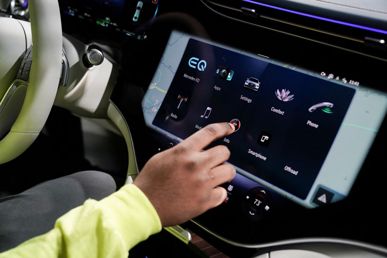 An employee uses one of the digital dashboard screens in the new all-electric EQS SUV during a tour at the opening of a Mercedes-Benz electric vehicle Battery Factory, marking one of only seven locations producing batteries for their fully electric Mercedes-EQ models, in Woodstock, Alabama, U.S., March 15, 2022. REUTERS/Elijah Nouvelage